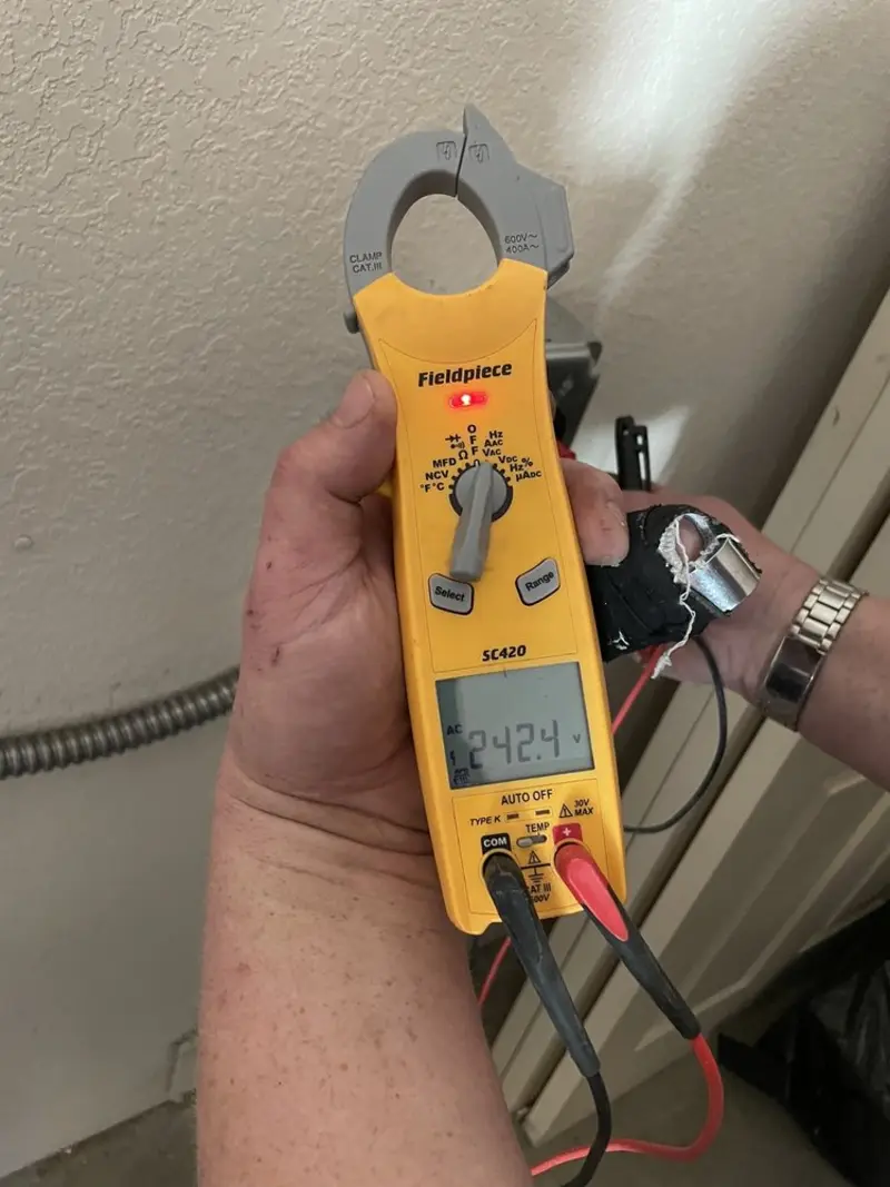Voltage testing with clamp meter during Outlet Installation in Schoharie